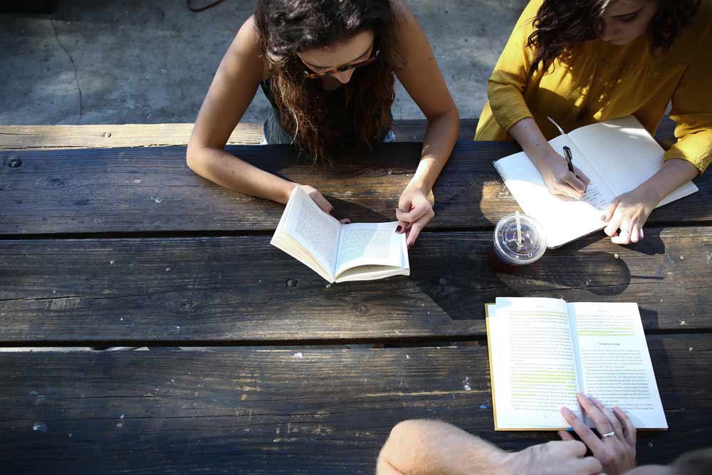 several girls sitting together studying