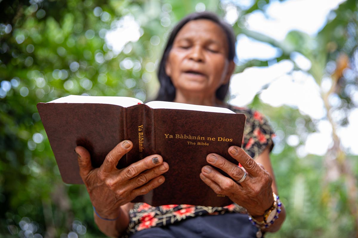 Isnag woman reading her Bible.