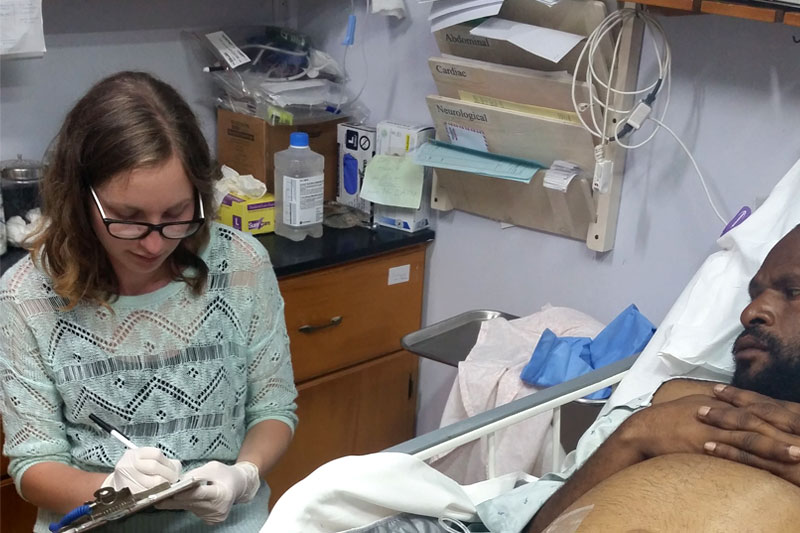 Leah at the bedside of a hospital patient