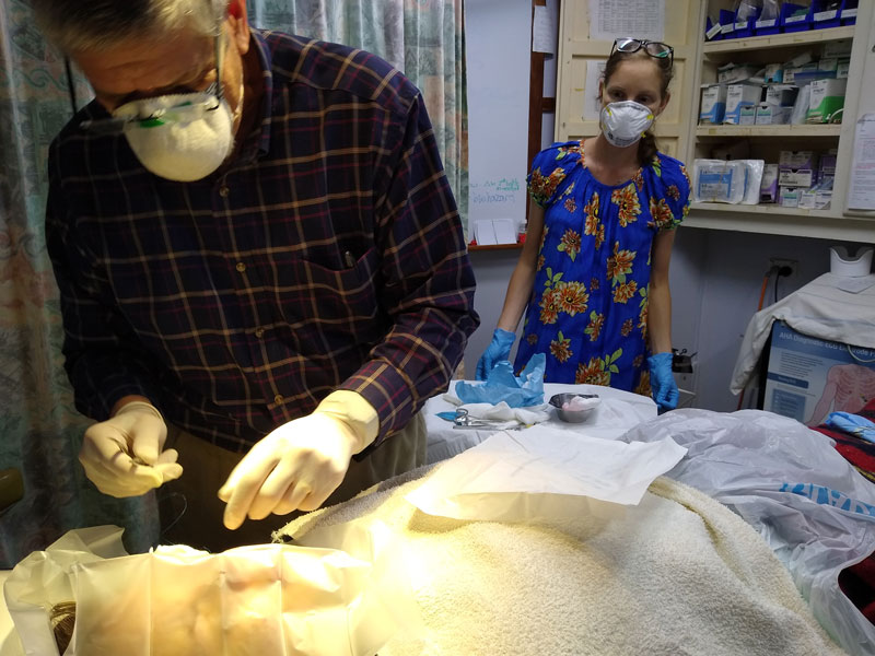 Doctor starting a medical procedure with Leah assisting